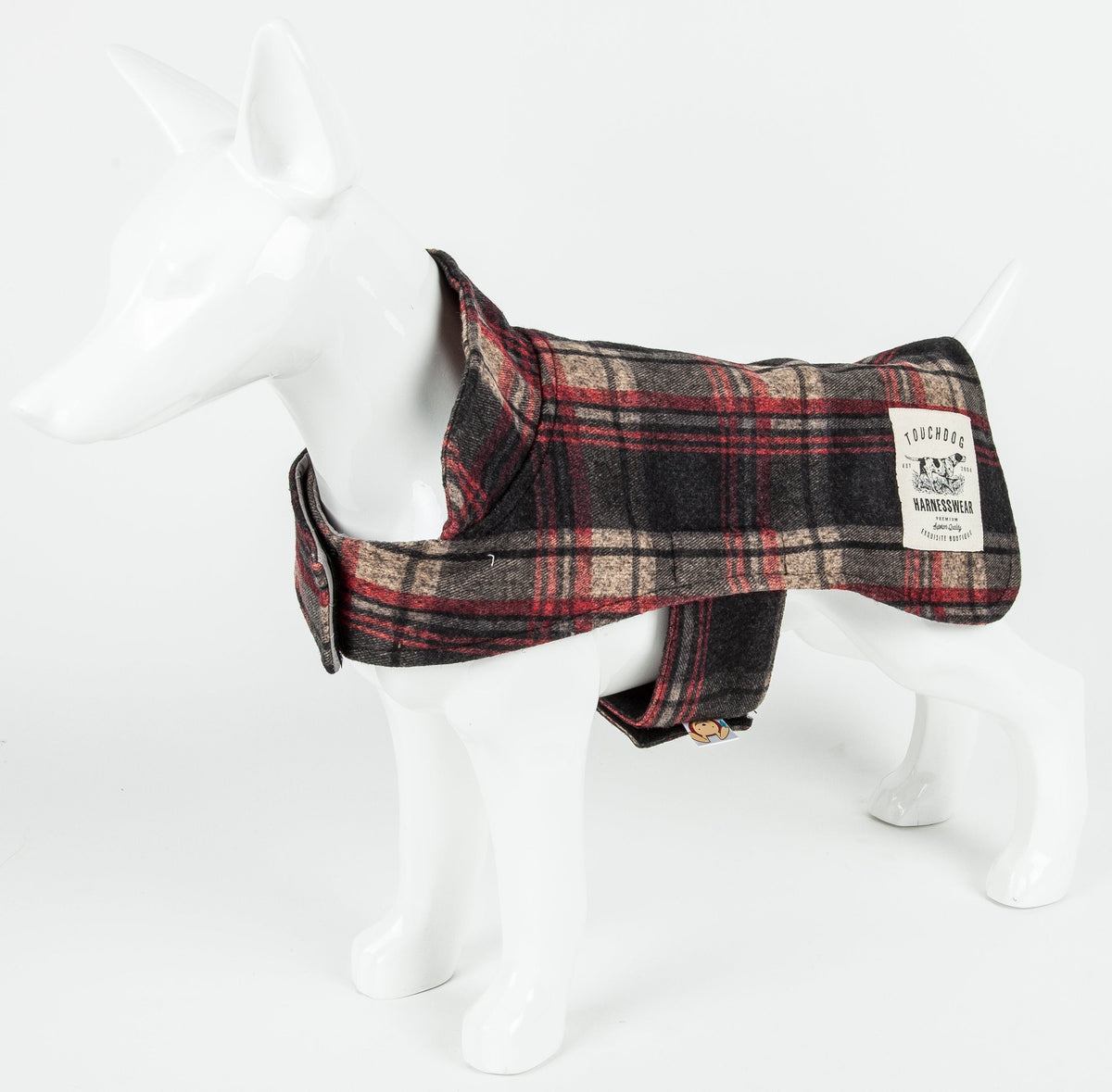 Dark red plaid dog jacket shown side-on, with a collar, belly strap, and branded patch.