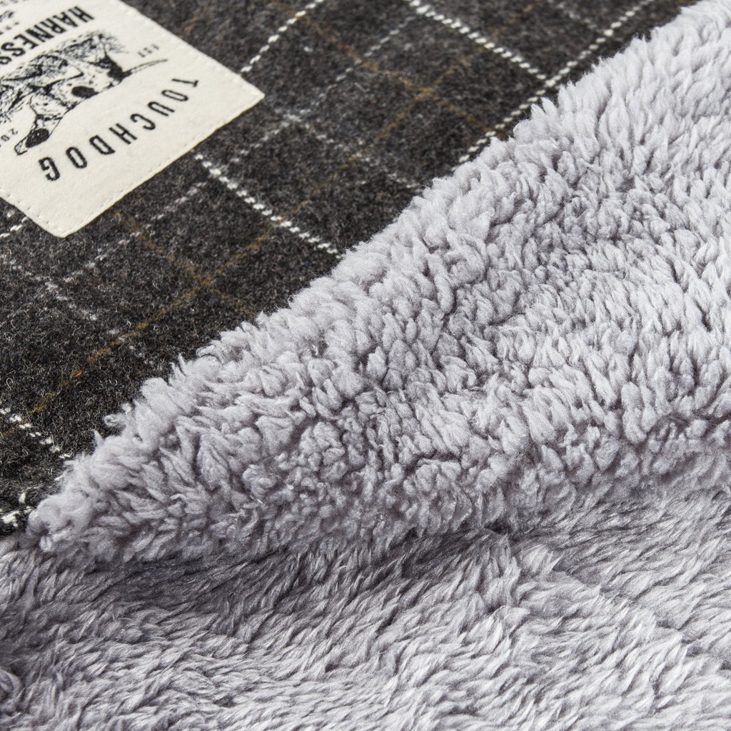 Close-up of dark gray plaid dog mat fabric and plush gray fleece lining