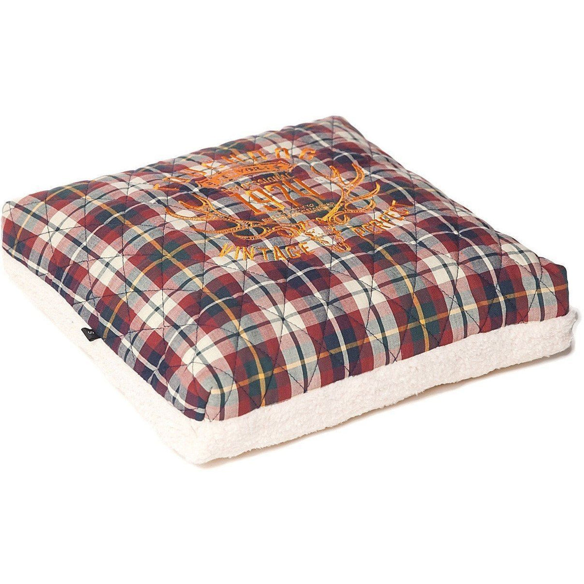 Plaid dog bed cushion with orange print and cream fleece base