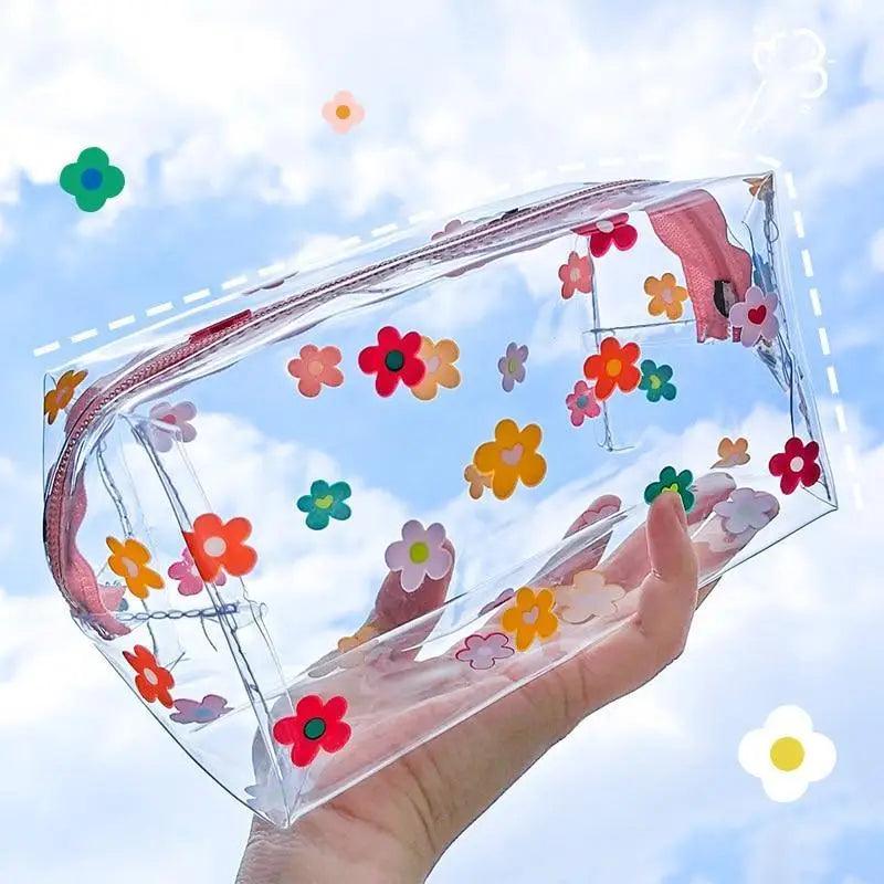 Transparent pencil case with multicolor flower print and pink zipper trim
