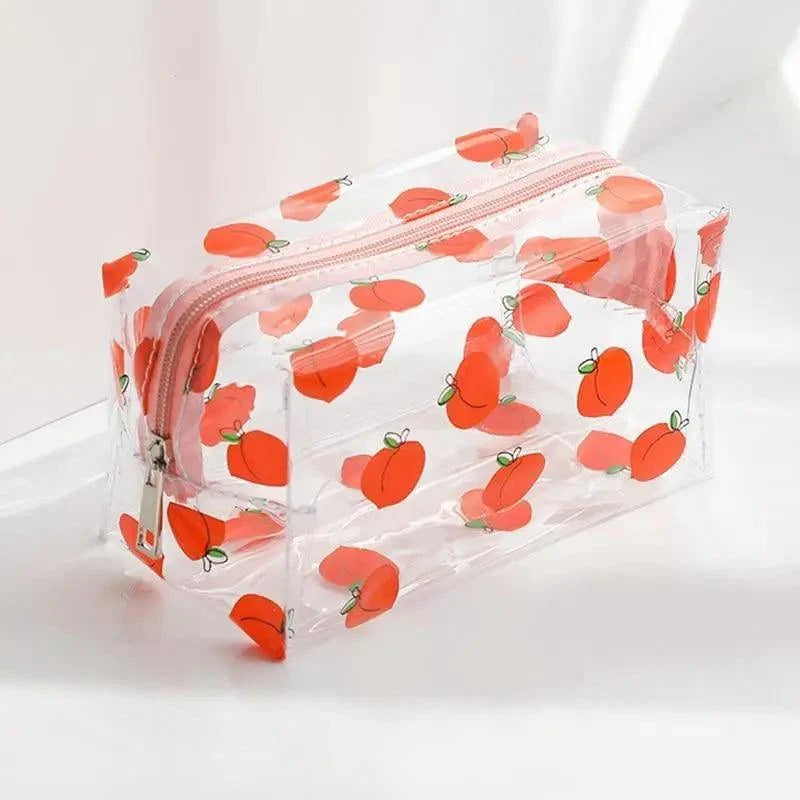 Transparent pencil case with orange fruit print and pink zipper