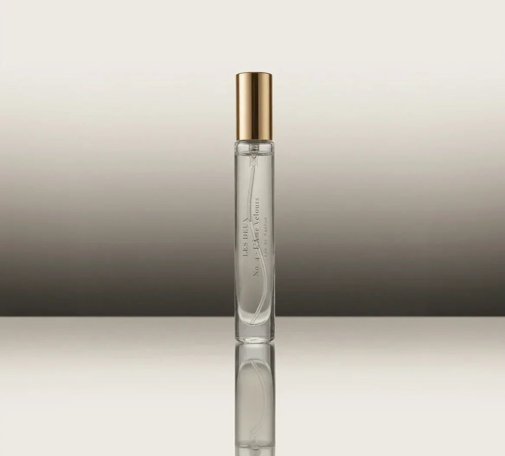 Glass perfume bottle with gold cap, slim side profile and label strip