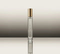 Glass perfume bottle with gold cap, slim side profile and label strip