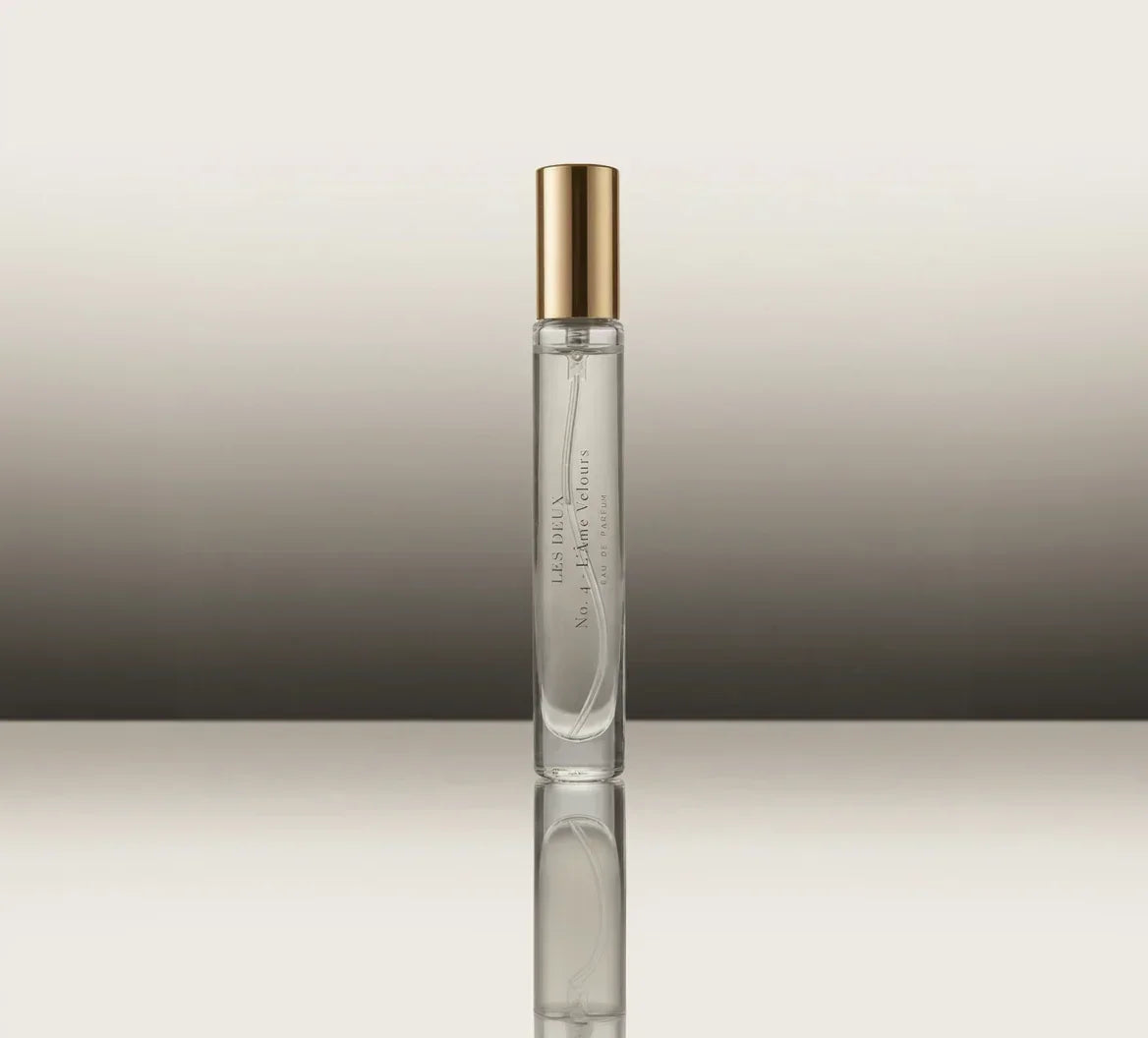 Glass perfume bottle with gold cap, slim side profile and label strip
