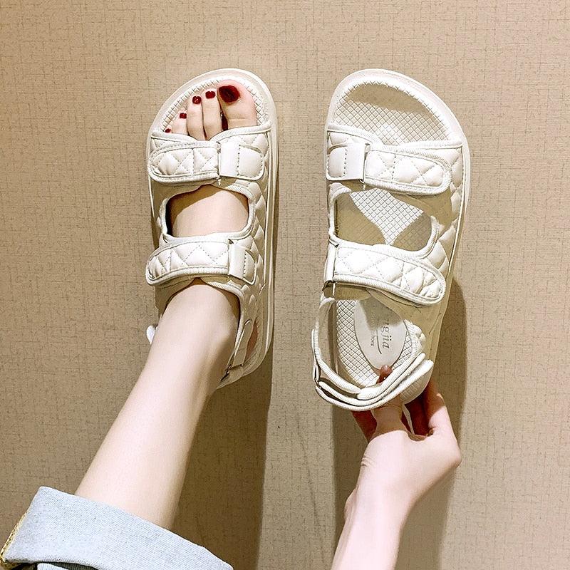 Women’s white flat sandals with two hook-and-loop straps and cushioned footbed