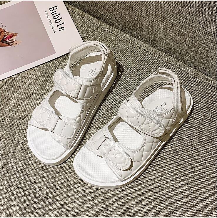 White chunky platform sandals with padded straps and hook-and-loop closures, open toe