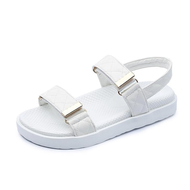 White flat slide sandals with two adjustable straps and thick molded sole