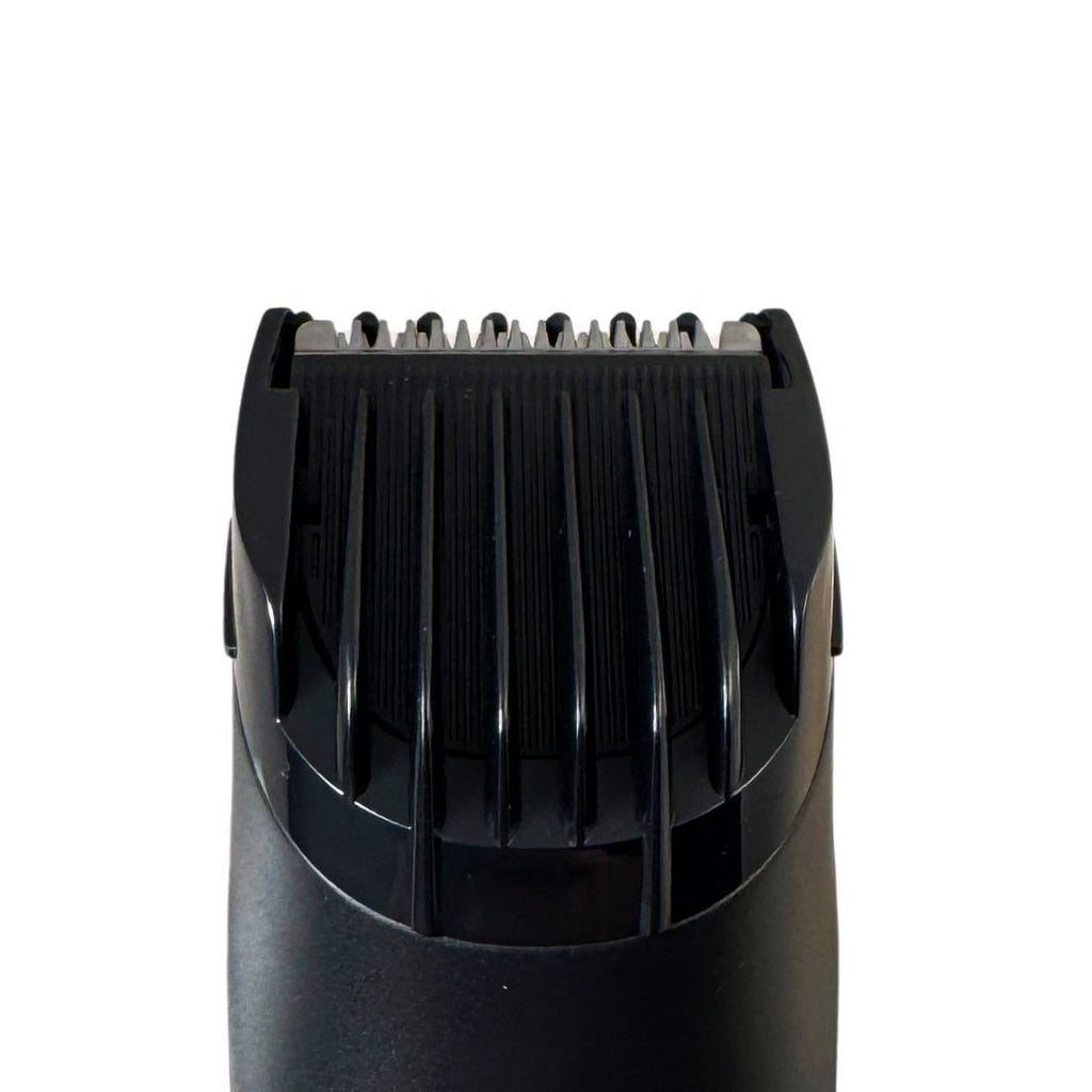 Black electric hair trimmer cutting blades close-up with comb guard