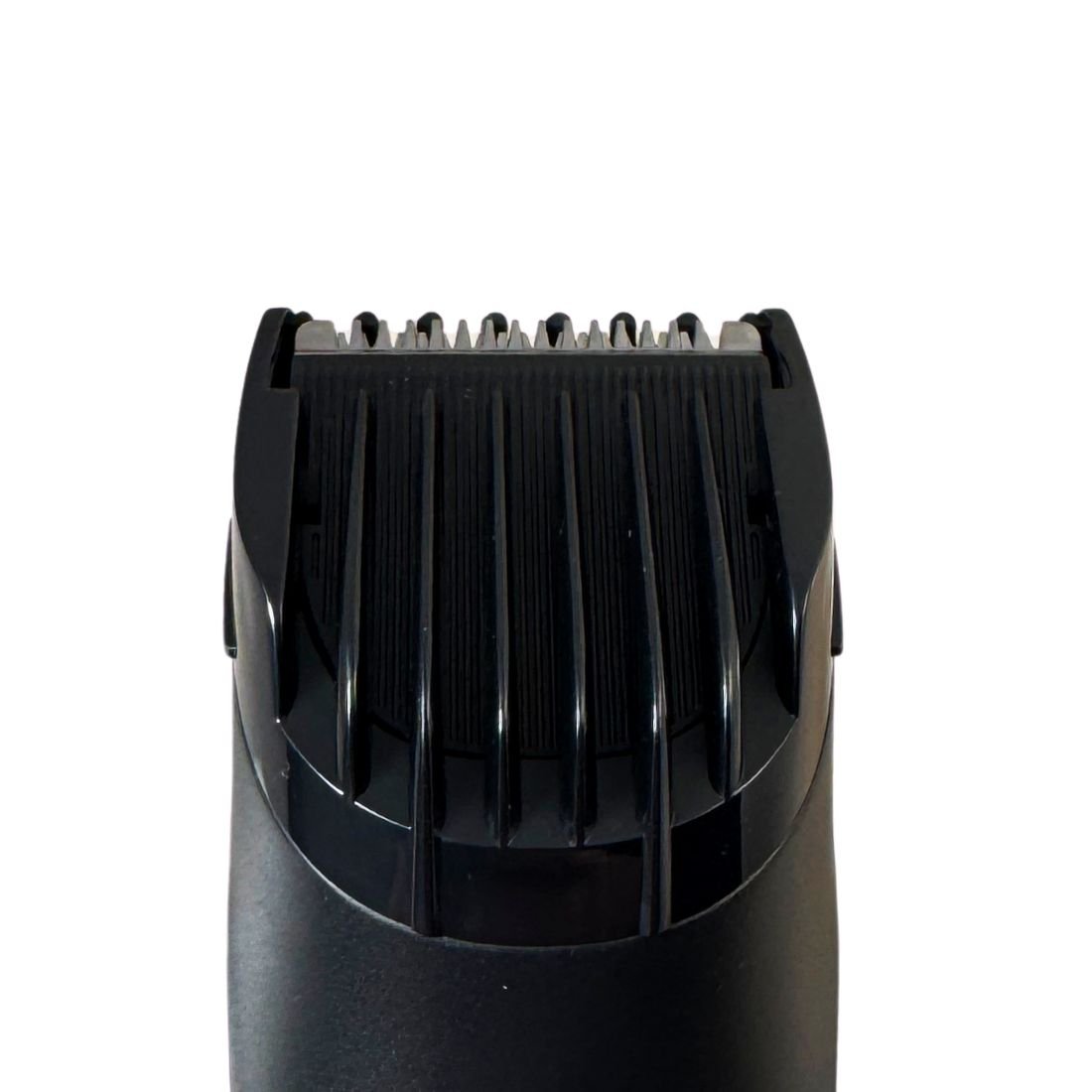 Black electric hair trimmer cutting blades close-up with comb guard