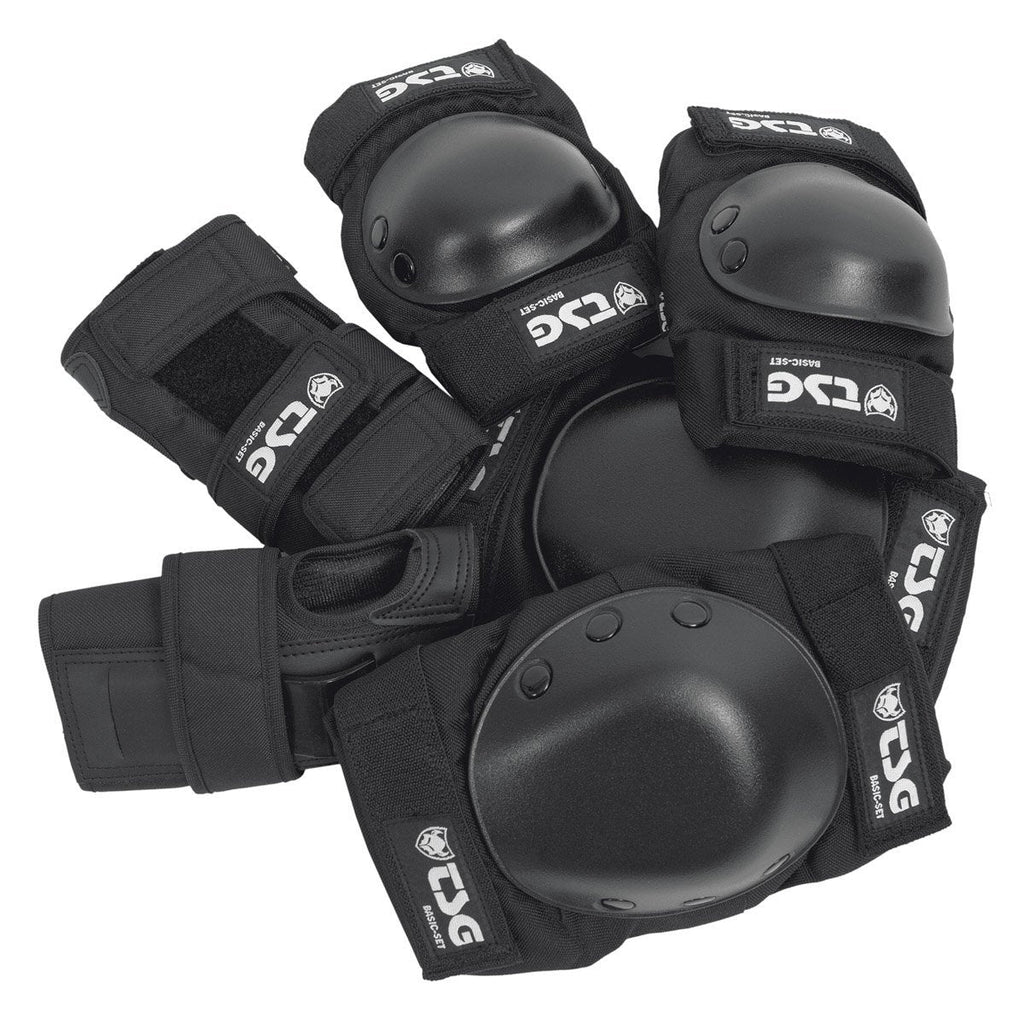 Black protective skate pads set laid out: wrist guards, elbow pads, knee pads