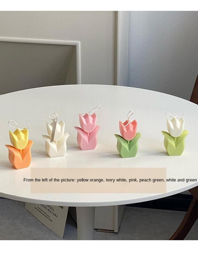 Set of tulip-shaped flower candles in yellow, white, pink, red, and green tones.