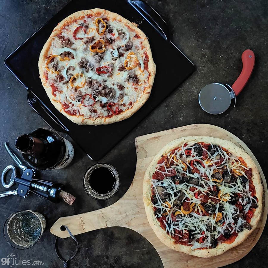 Gluten-free pizza with mixed toppings and melted cheese on a tray