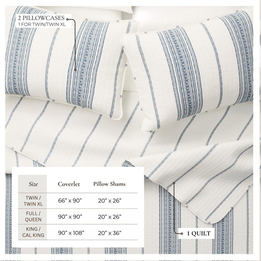 Striped quilt with cream base and blue vertical stripes, rolled pillow shams visible.