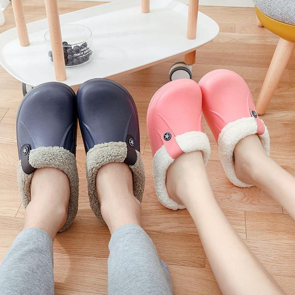 Navy and pink fur-lined winter clogs with plush cuffs and star button emblem