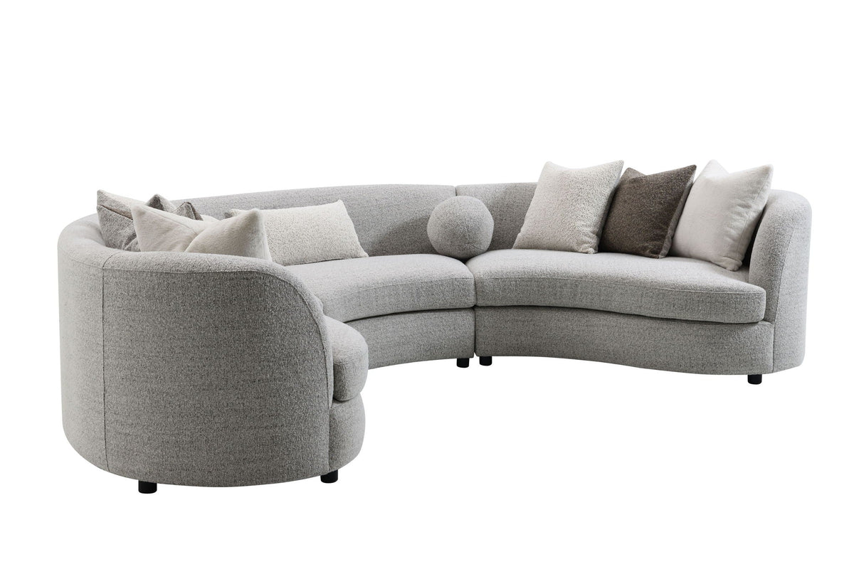 Light gray boucle sectional sofa with large rounded arm and three back pillows