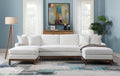 Ivory sectional sofa with chaise, four throw pillows, and dark wood arms