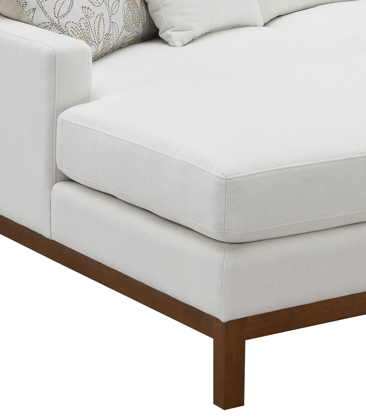 Ivory sectional sofa corner with thick armrest and dark wooden legs