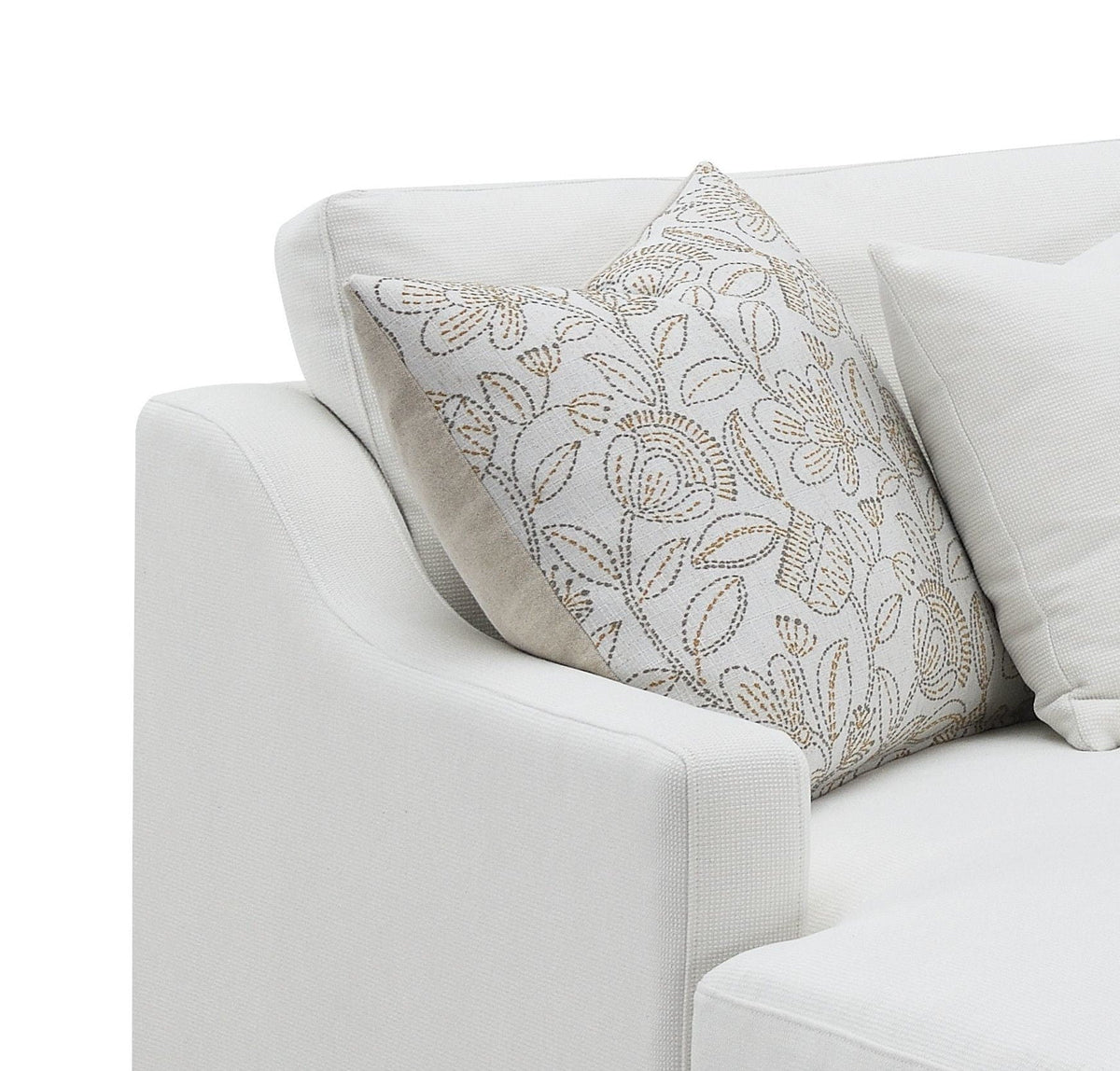 Ivory sofa chaise with patterned accent pillow and smooth seat cushion