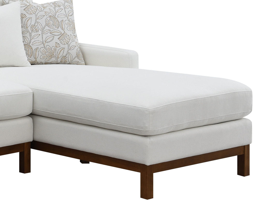 Ivory sectional chaise ottoman with upholstered top and dark wood legs