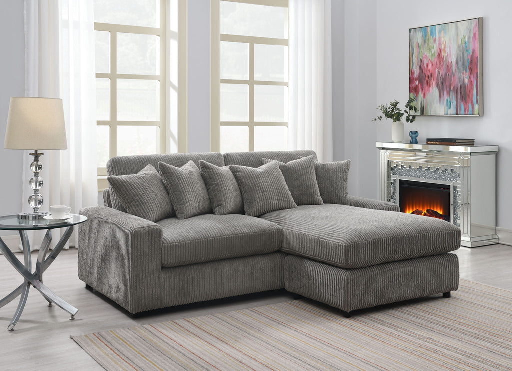 Gray reversible sectional sofa with 6 textured throw pillows, L-shaped chaise sectional.