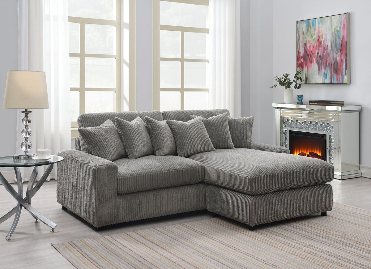 Gray reversible sectional sofa with 6 textured throw pillows, L-shaped chaise sectional.