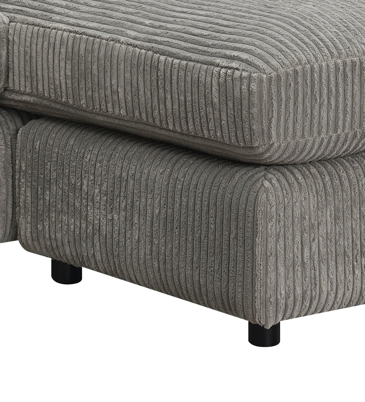 Gray corduroy-textured sectional sofa arm and seat cushion close-up with piping