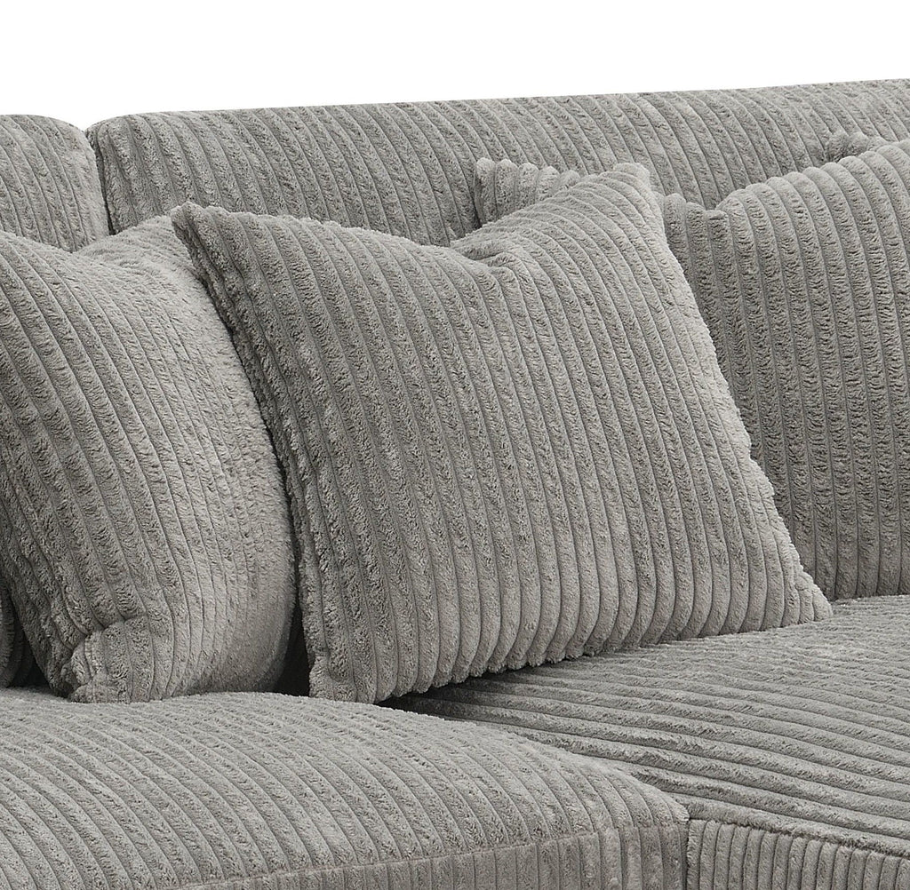 Gray sectional sofa with ribbed cushions and two decorative pillows