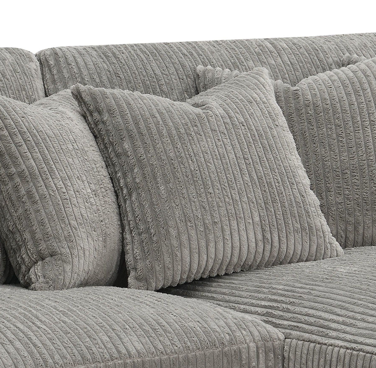 Gray sectional sofa with ribbed cushions and two decorative pillows