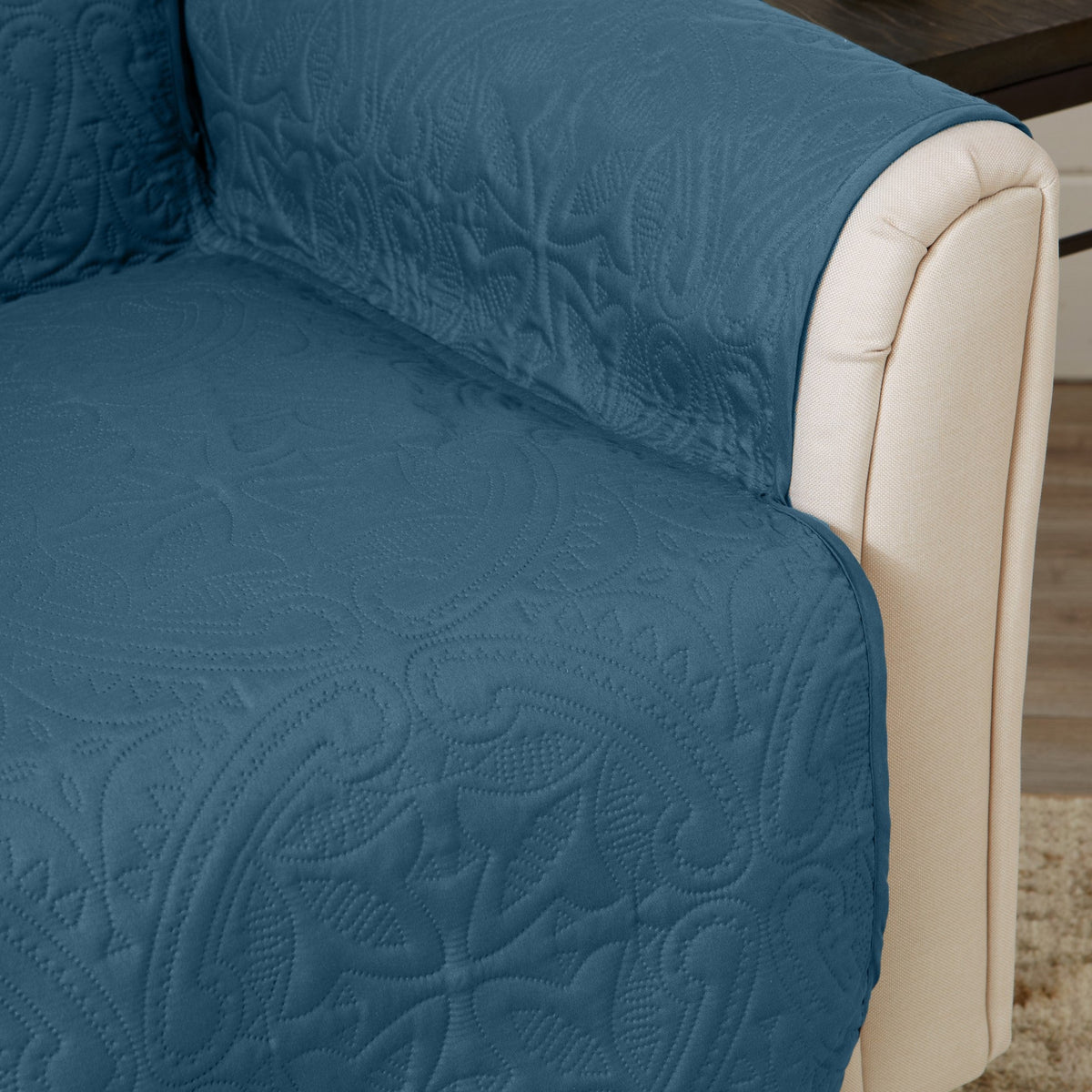 Blue quilted recliner protector with beige side trim and patterned seat