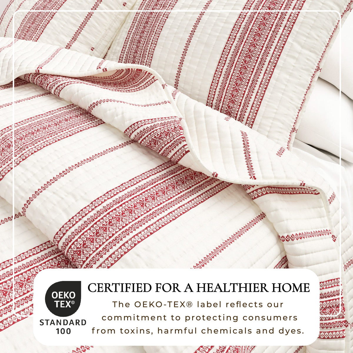 Cream and red striped quilt close-up with stitched channels and scalloped edge fold