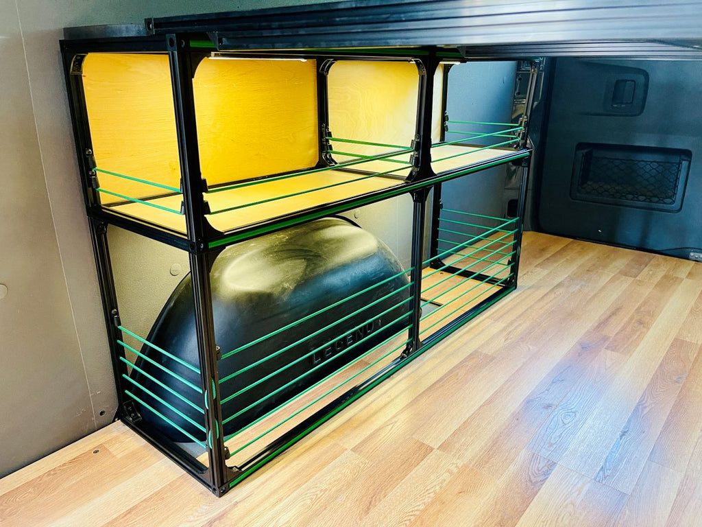 Van bed frame with light wood platform and stacked wire shelving compartments underneath