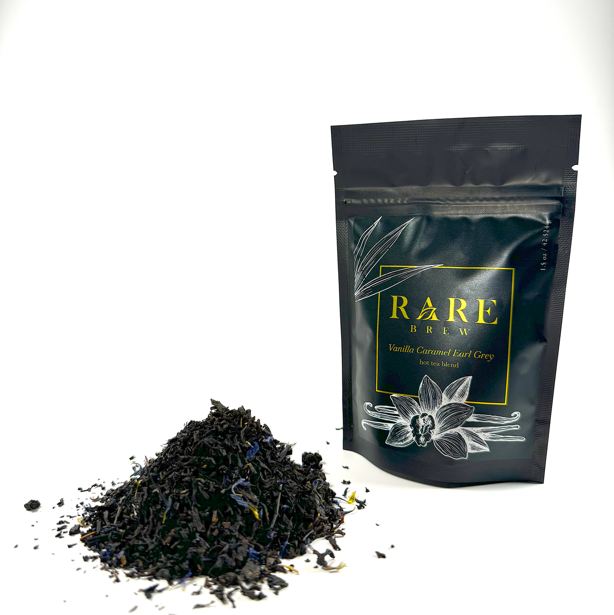 Loose leaf tea pouch with scattered black tea leaves