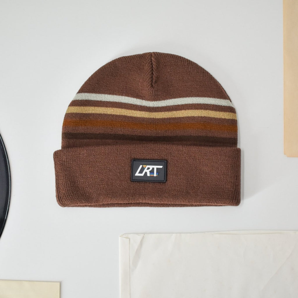 Brown cuffed knit beanie with multicolor striped band and LRT logo patch