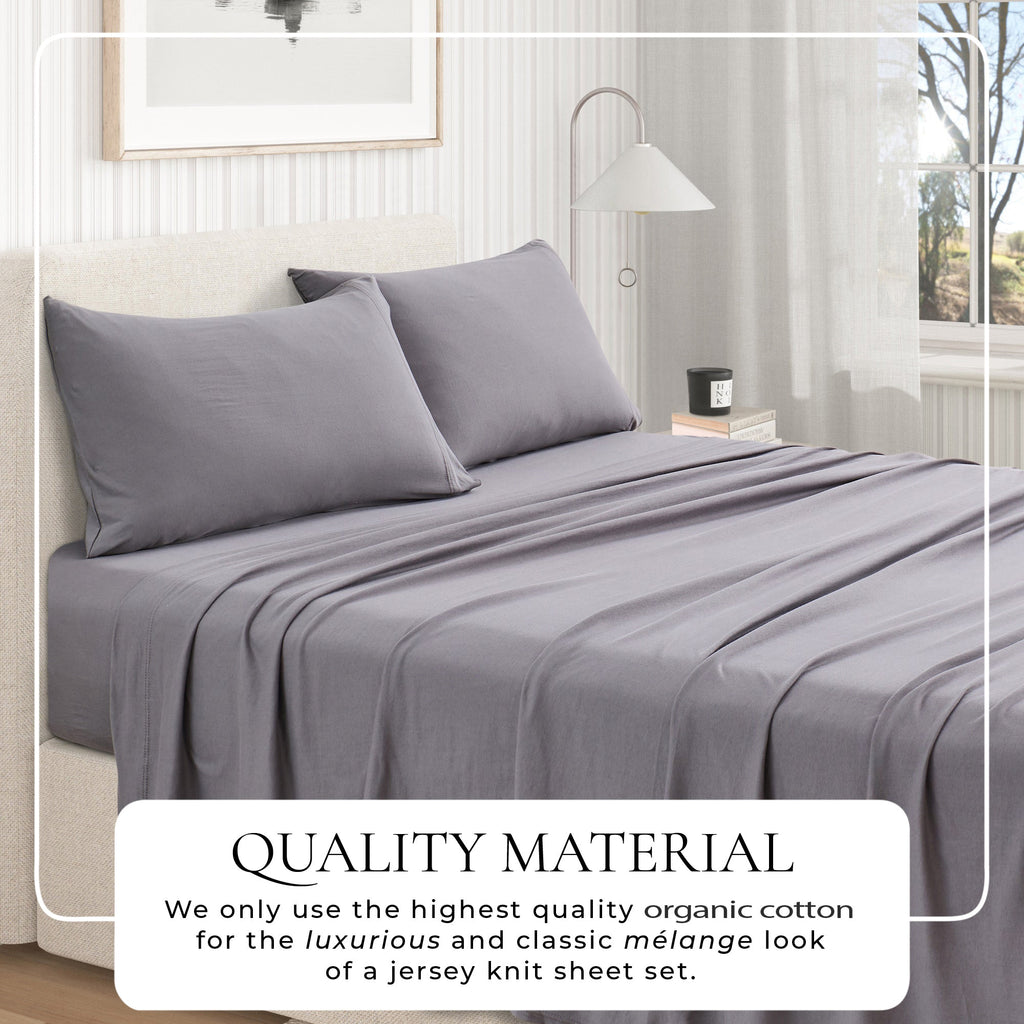 Jersey knit sheet set on bed with pillows, dark grey