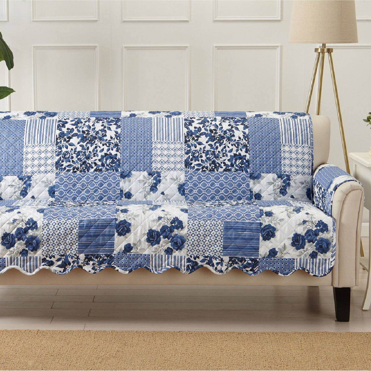 Full loveseat protector cover in blue and white patchwork with floral, tile, and stripes