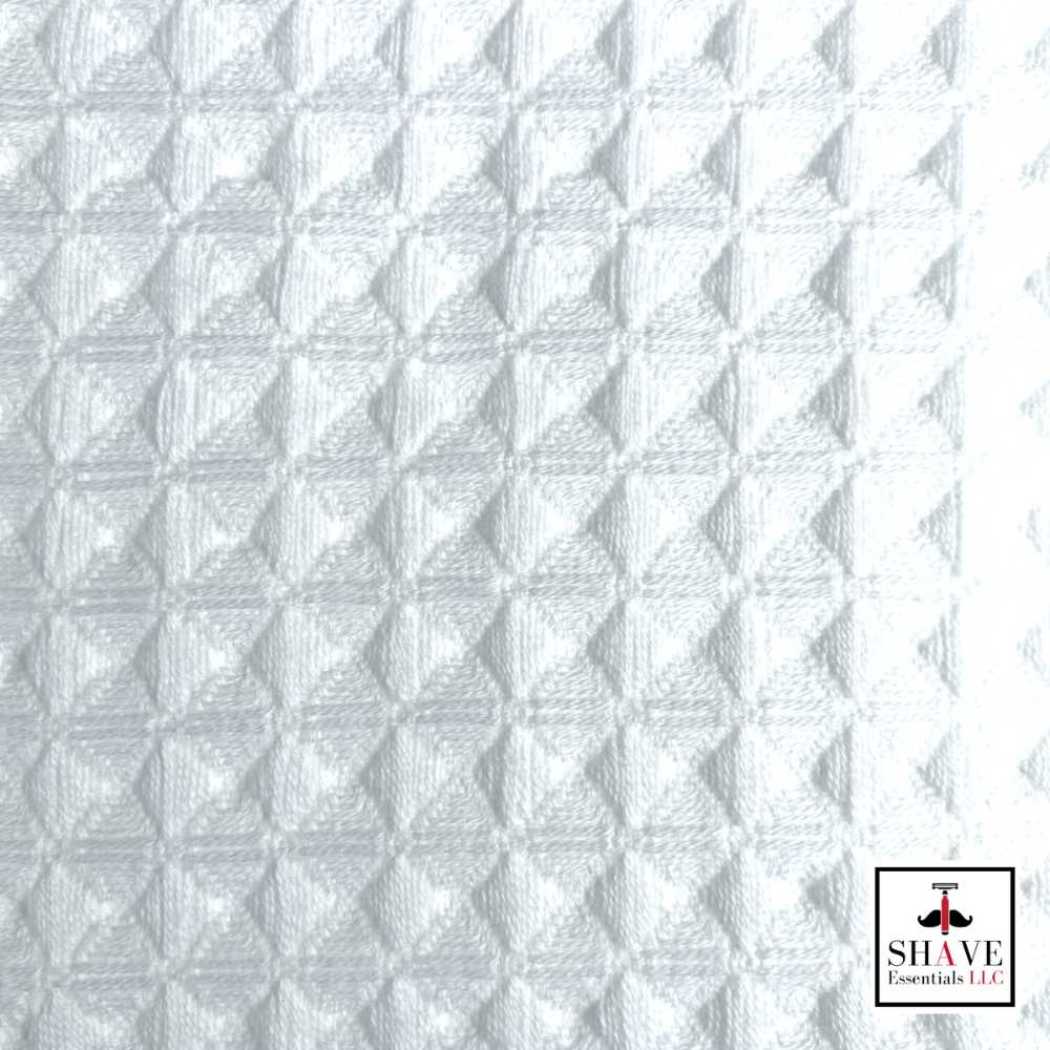 Waffle weave towel fabric close-up in white with embossed diamond texture