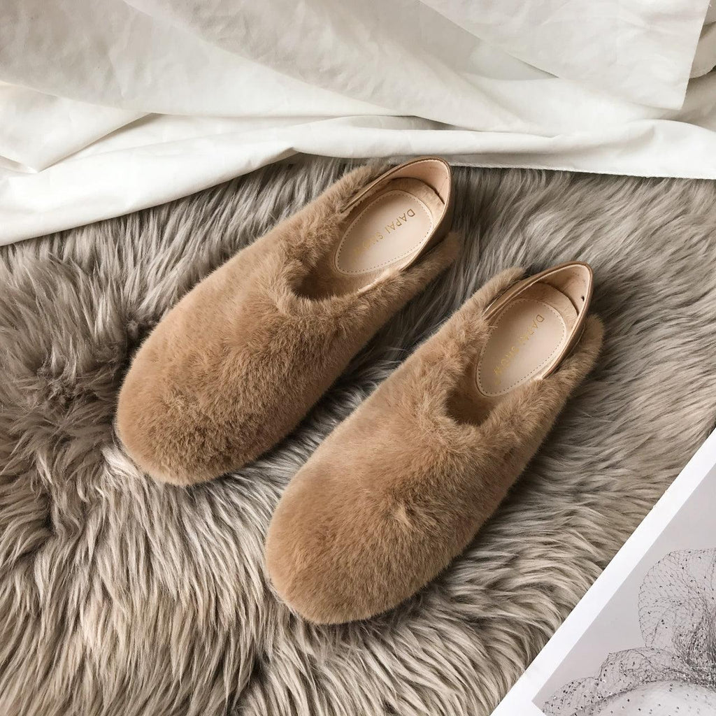 Mixed-color faux-fur slip-on loafers with round toe and tan footbed, pair on gray rug