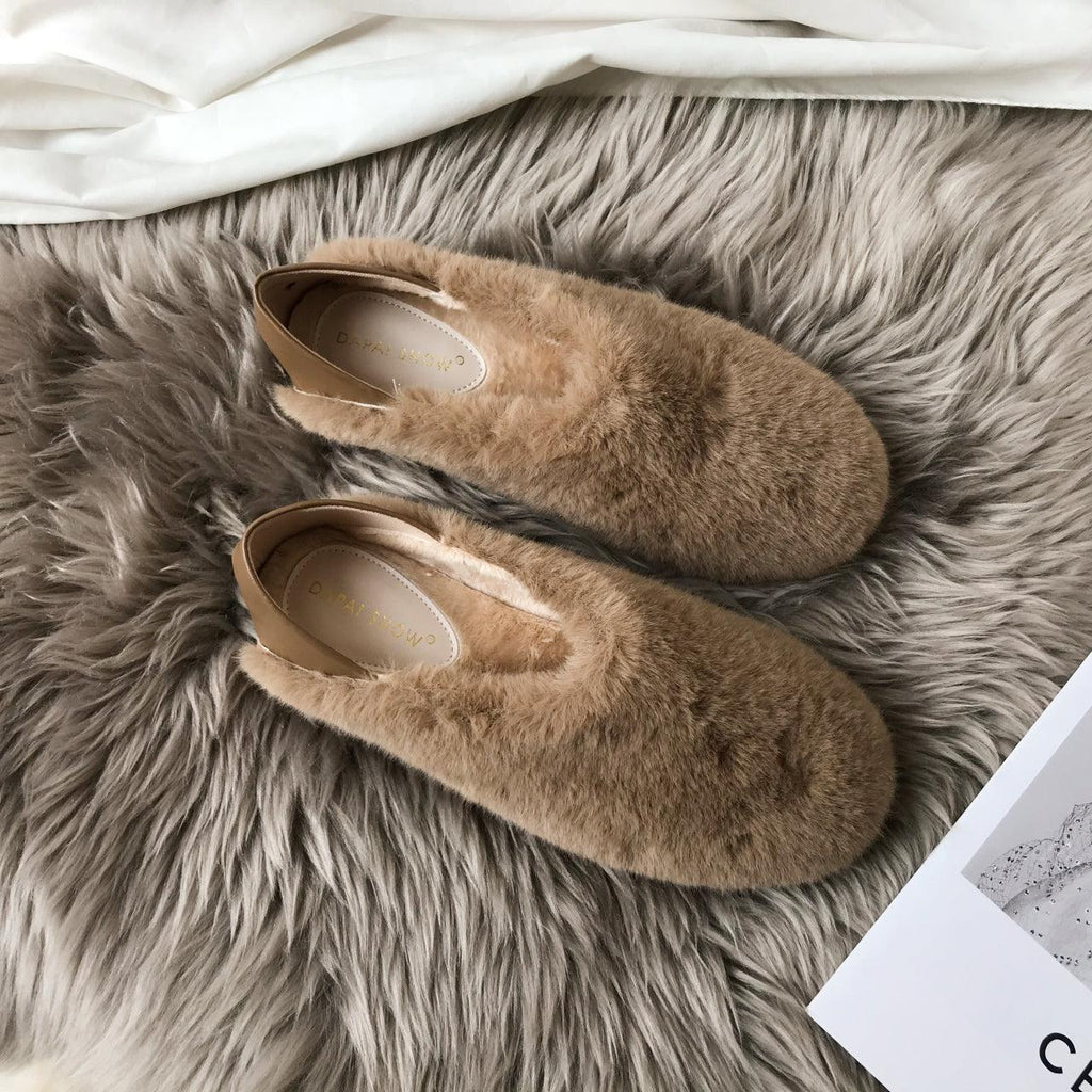 Brown faux-fur round-toe slip-on loafers with tan footbed, pair on soft rug