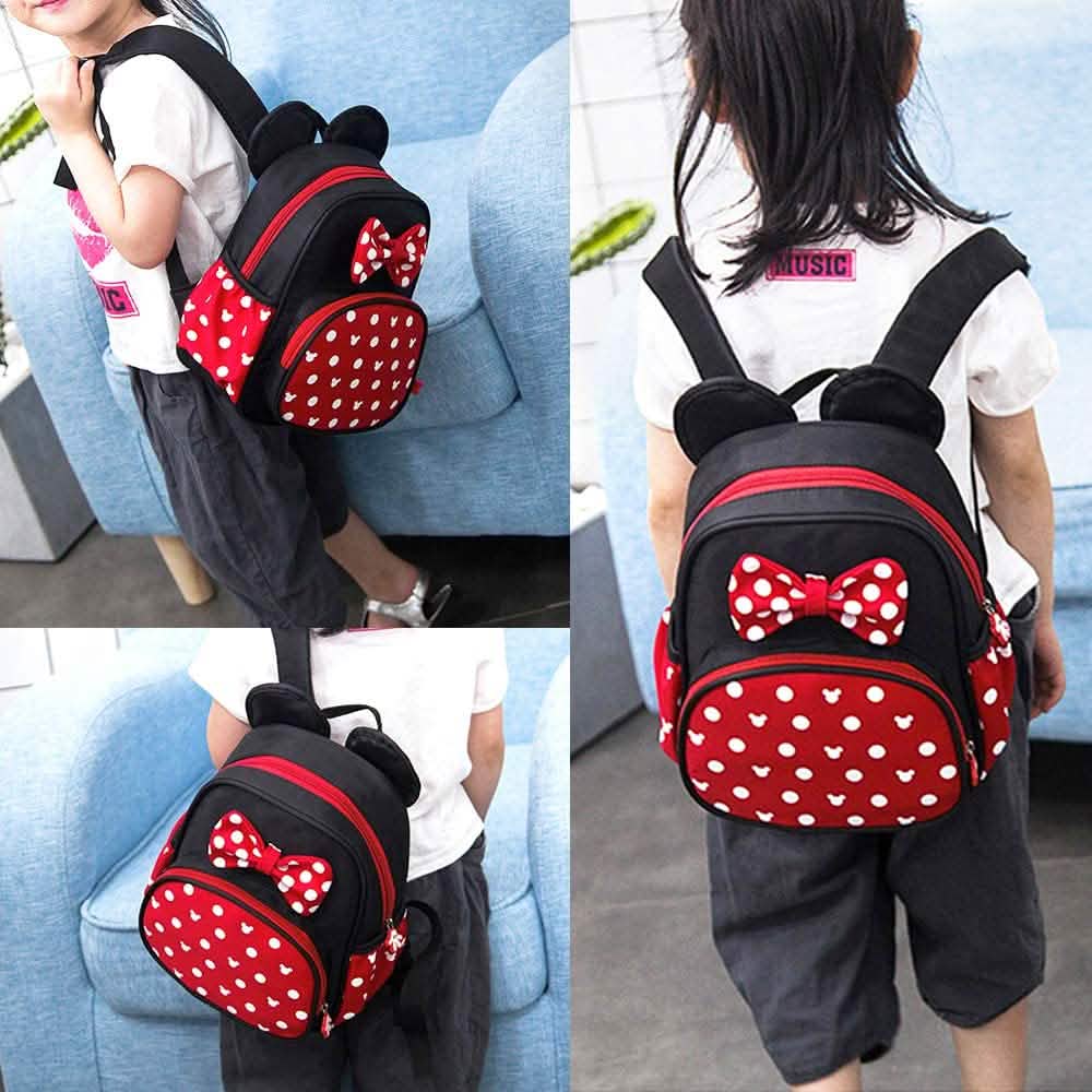 Mini mouse backpack worn by child, side and back angles with red bow accents