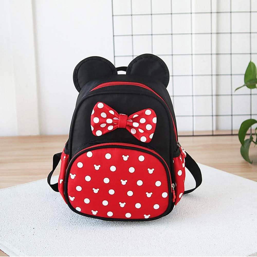 Mini mouse backpack front view with red bow and red polka-dot panel on black