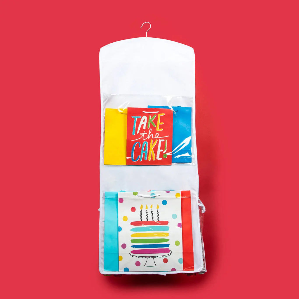 White hanging gift wrap organizer with two clear front pockets for gift wrap