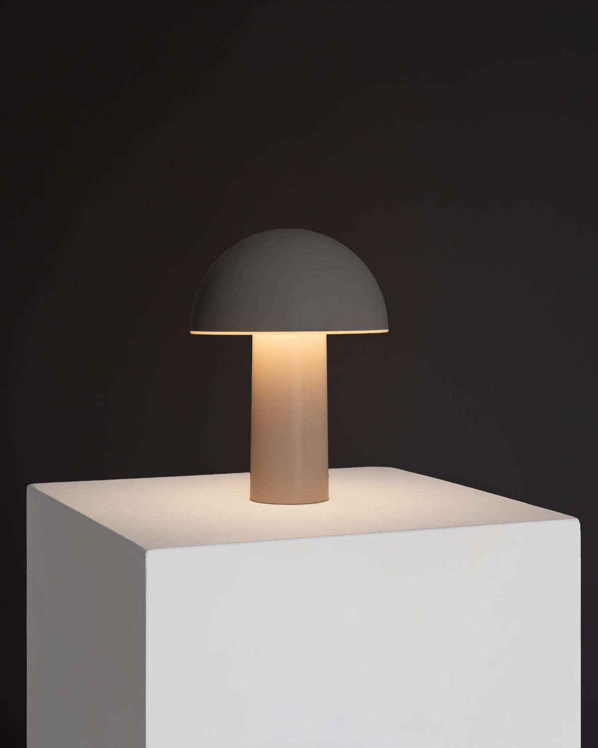 Cream portable lamp with dome shade and slim cylindrical base, soft warm light
