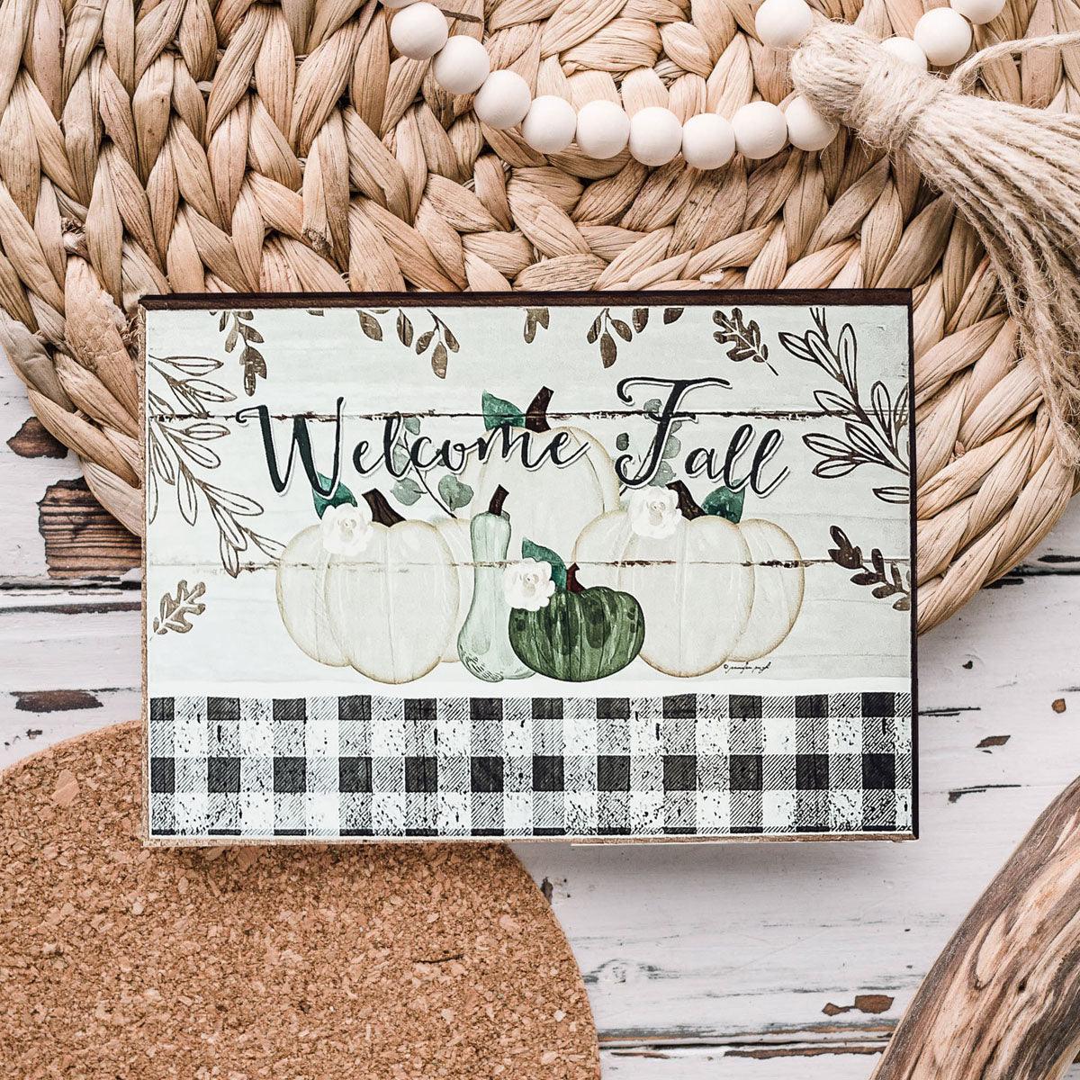 Fall greeting card with pumpkins, a green tractor truck, and buffalo plaid border