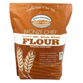 Whole wheat flour pouch with Bronze Chief label and wheat emblem, brown paper bag.