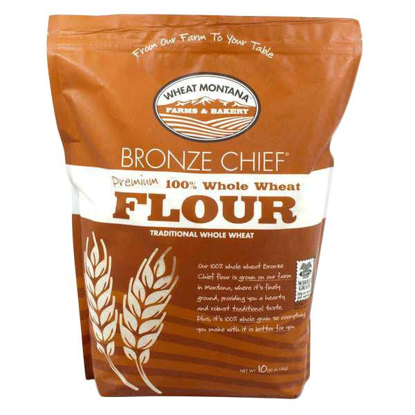 Whole wheat flour pouch with Bronze Chief label and wheat emblem, brown paper bag.