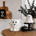 White ghost-shaped mug with smiley face and handle