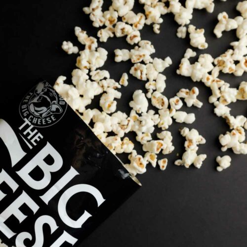 White cheddar popcorn pouch with Big Cheese branding and popped kernels