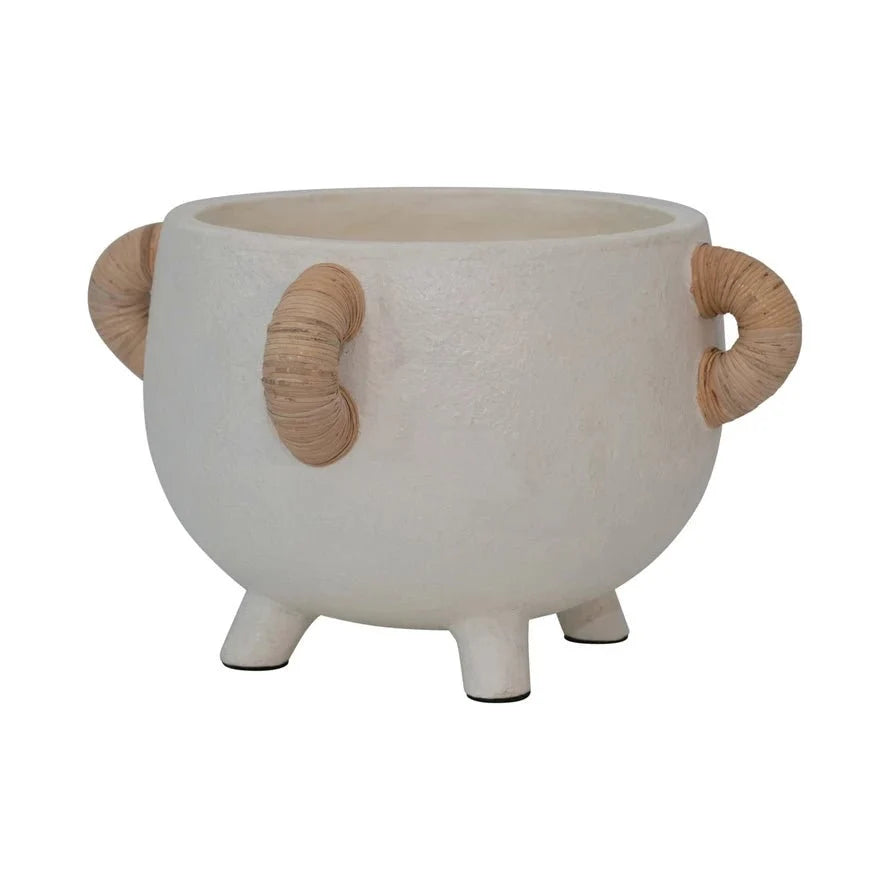 White ceramic planter with rattan loop handles and three small feet
