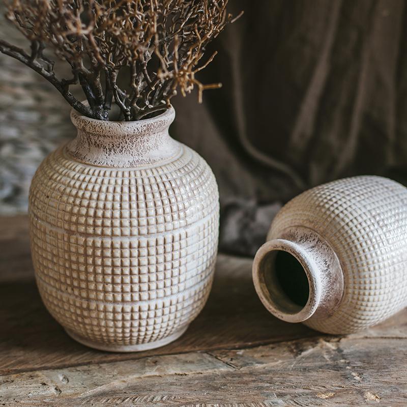 Textured ceramic jar vase with open mouth and short, wide base