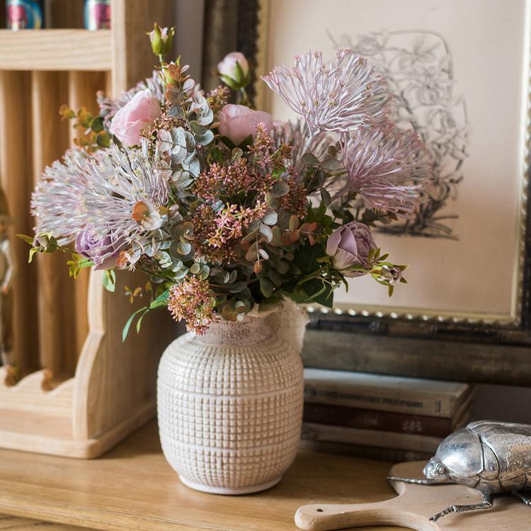 Small textured ceramic jar vase with open neck and rounded body
